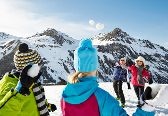 Family having a snowball fight on mountain
