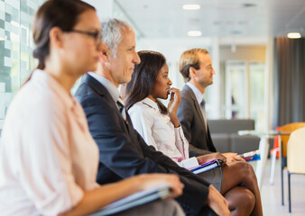 Business people sitting in office together