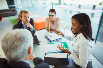 Business people talking at table in office building