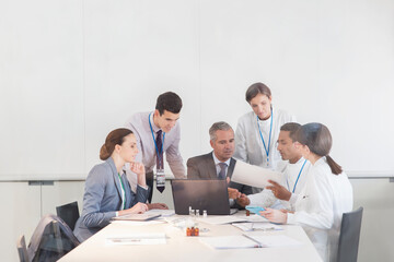 Scientists and business people talking in conference room