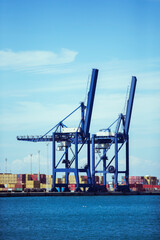 Fototapeta premium Cranes and cargo containers at waterfront