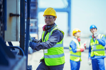 Worker climbing cargo crane