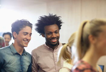 University students chatting during break in classroom