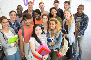 Group portrait of university students standing together in corridor
