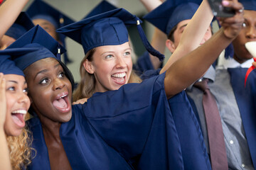 University students taking selfie after graduating