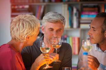 Older friends tasting white wine
