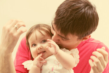 Happy father and baby girl at home