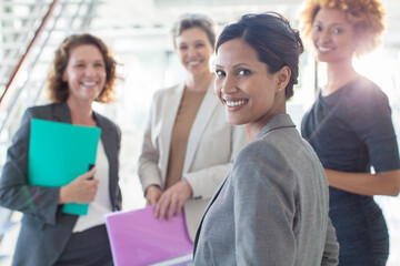 Portrait of four smiling businesswomen in office