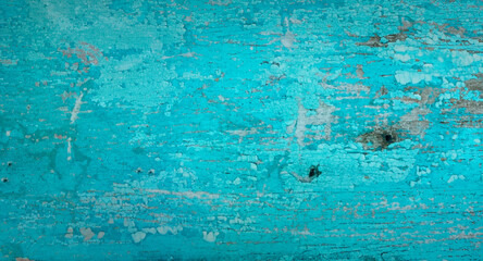 Cracked painted blue teal background with texture and grunge finish