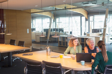 Businesswomen shaking hands in office meeting