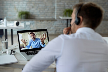Obraz na płótnie Canvas Close-up of entrepreneurs having online business meeting over laptop.
