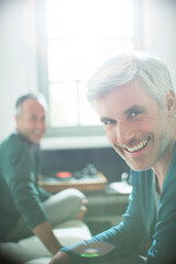 Gay couple relaxing together with record player