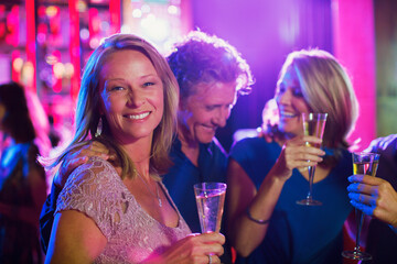 Friends with champagne flutes having fun in nightclub