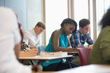 Fototapeta premium View of students sitting at desks during test in classroom 