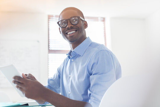 Portrait Young Businessman Wearing Glasses Blue Shirt Holding Digital Tablet In Office