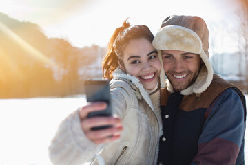 Couple taking selfie in snow