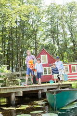 Obraz premium Brothers, father and grandfather walking on dock
