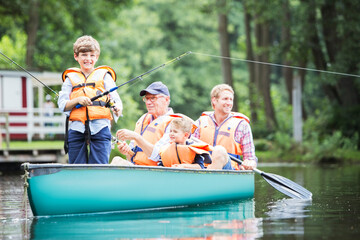 Brothers, father and grandfather fishing in lake