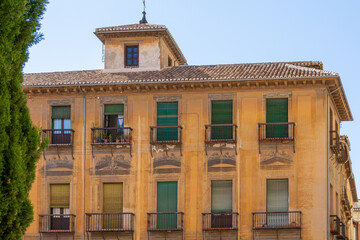 Old building with shutters on the balconies in the Plaza de Las Pasiegas next to the Cathedral of Granada