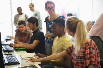 University students studying on computers and discussing