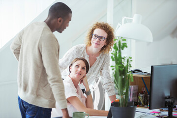 Office workers talking at desk