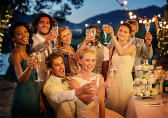 Wedding guests toasting champagne during wedding reception in garden - obrazy, fototapety, plakaty