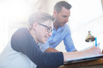 Obraz premium Father helping teenage son with his homework