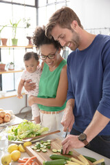 Obraz na płótnie Canvas Happy family preparing meal in domestic kitchen