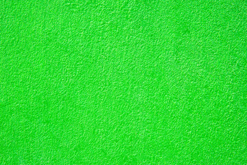 Cement wall with green paint color closeup for background.