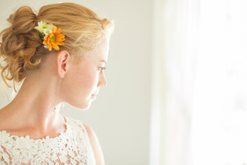 Portrait of bride looking out of window