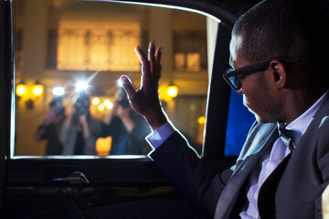 Celebrity in limousine waving at paparazzi photographers - obrazy, fototapety, plakaty