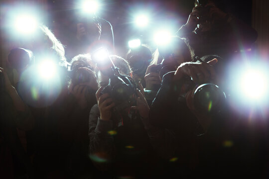 Close up of paparazzi photographers pointing cameras