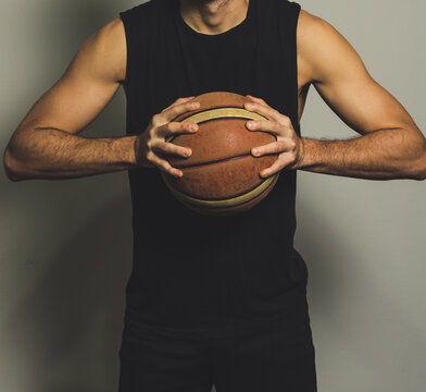 Young Man Holding A Basketball