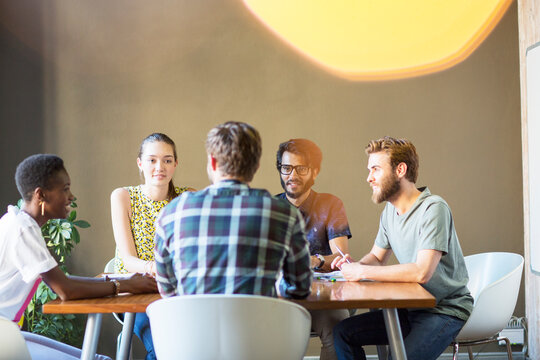 Casual business people meeting at table in office