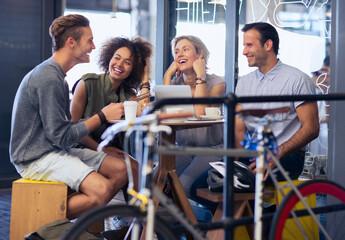 Friends hanging out in cafe behind bicycle
