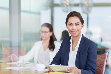Portrait confident businesswoman using digital tablet