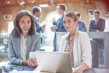 Portrait confident businesswomen working at laptop in office