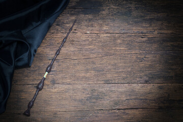 Obraz premium Magic wand on wooden table, Magic wand Wizard tool on vintage wooden background.