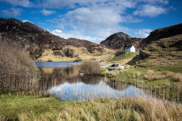 Scenic view of sunny remote lake and rural landscape, Scotland