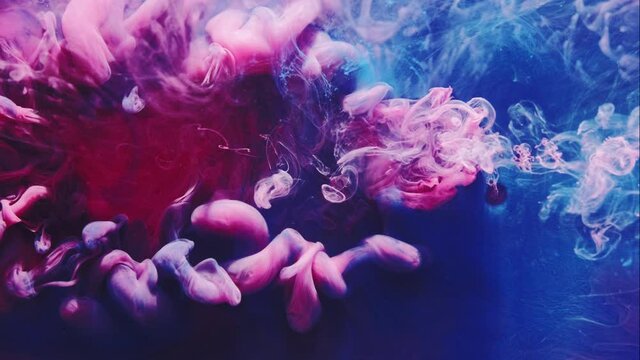 Color ink splash. Mysterious illusion. Pink smoke cloud puff on blue steam abstract background.