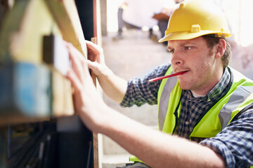 Construction worker using level tool