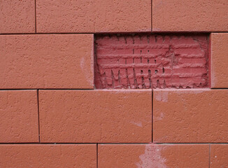 brick wall with one missing fragment, textured surface
