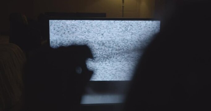 Scary Clip of a TV with no Signal with Silhouette of a Hand in the Foreground