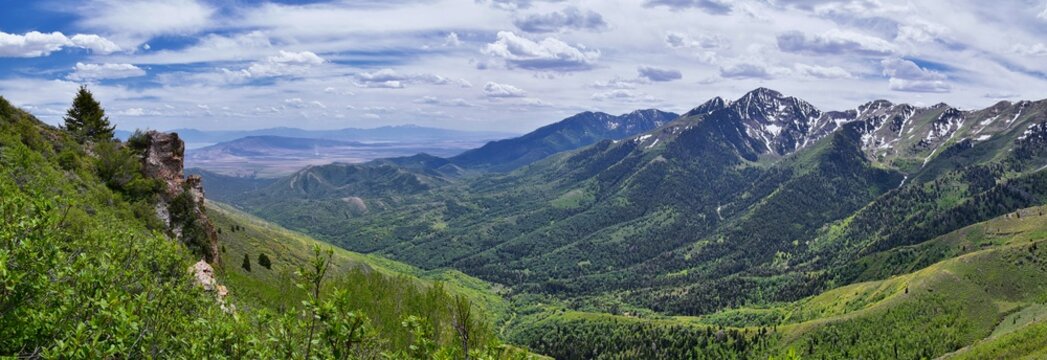 Rocky Mountain Wasatch Front peaks, panorama landscape view from Butterfield Canyon Oquirrh range toward Provo, Tooele Utah Lake by Rio Tinto Bingham Copper Mine, Great Salt Lake Valley in spring. Uta