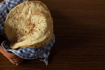 Corn tortilla in basket with checkered tablecloth, delicious Latin American vegan food