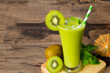Kiwi yogurt fruit juice smoothie green colorful fruit juice milkshake blend beverage healthy high protein the taste yummy In glass drink episode morning on wood background.
