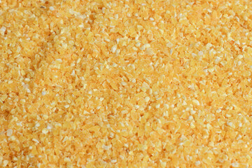 Cornmeal or corn flour background, macro concept