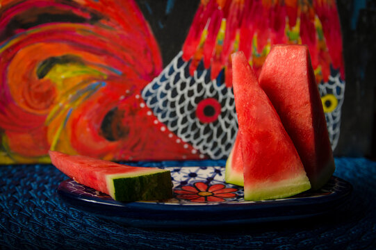 Watermelon over colorful dish and with paint background