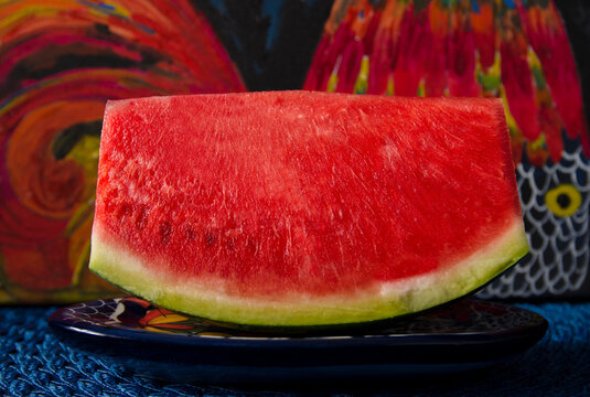 Slice of ripe watermelon with a paint background 