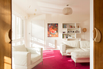 Sunny living room with white leather furniture